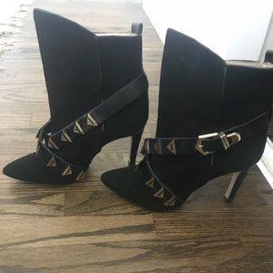 Black ankle boots with gold hardware